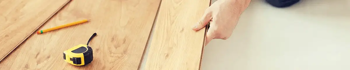 A professional installing wood flooring in St Paul, MN