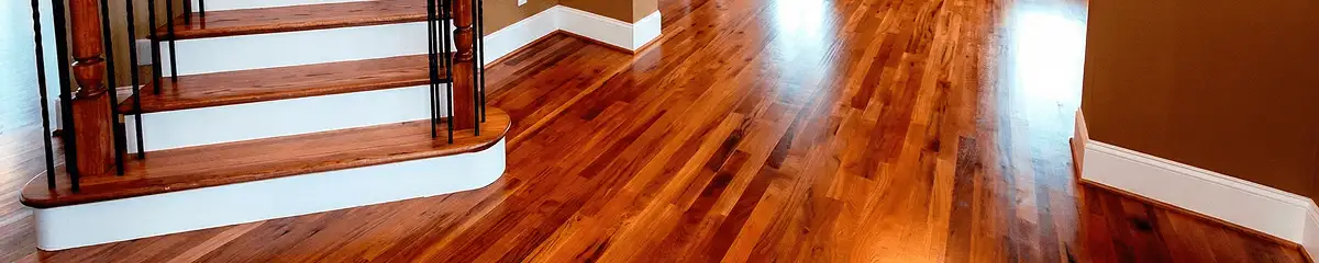 Base floor of a staircase with professionally restored wood flooring in St Paul MN