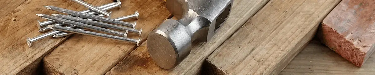 Hammer and nails on hardwood flooring boards in St Paul, MN