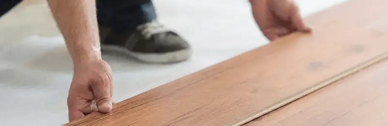 A professional installing laminate flooring in St Paul, MN